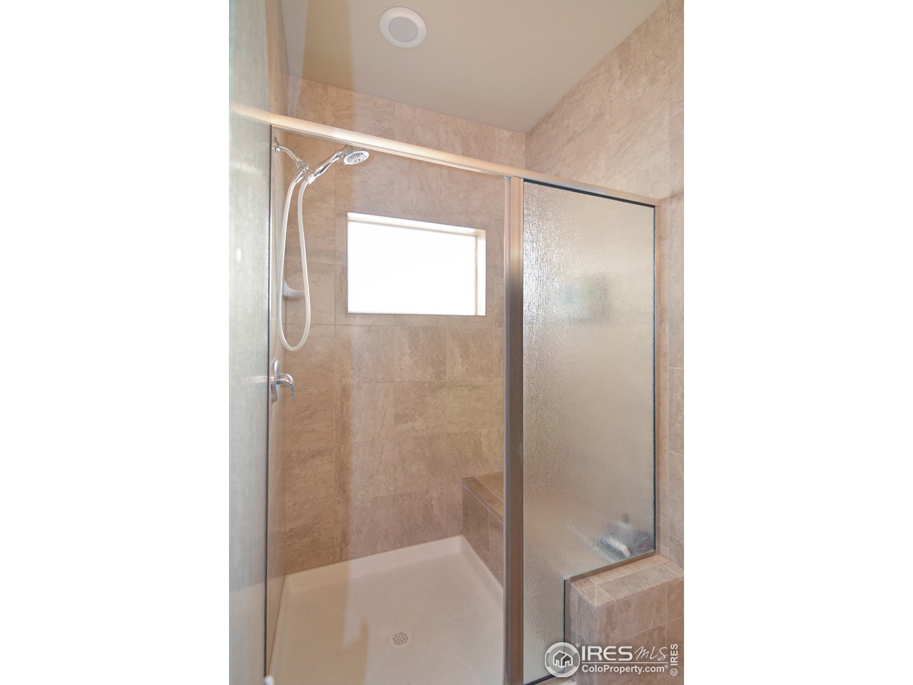2045 Reed Grass Way Colorado Springs, CO 80915 - Photo 17 of 33 a bathroom with a glass shower door