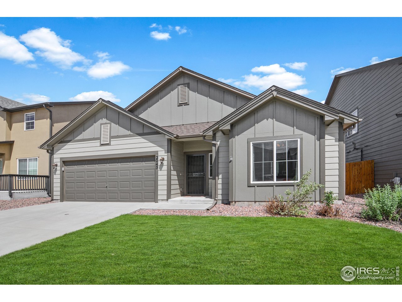 2045 Reed Grass Way Colorado Springs, CO 80915 - Photo 2 of 33 a front view of a house with a yard and garage
