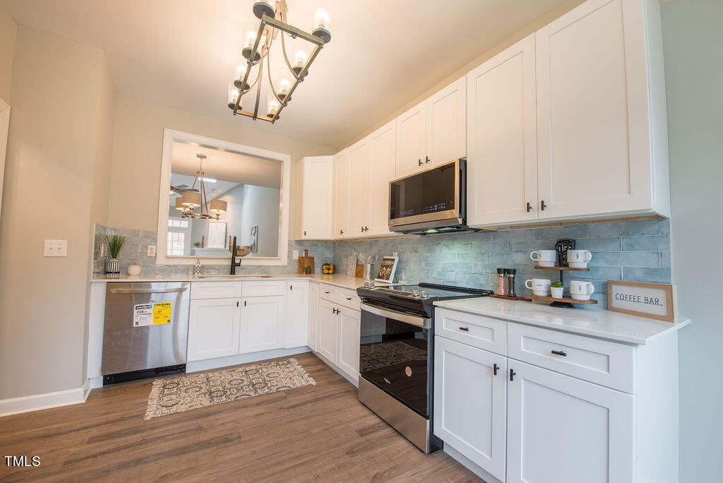 8728 Compass Lane Raleigh, NC 27615 - Photo 2 of 17 Kitchen Open to Family Room