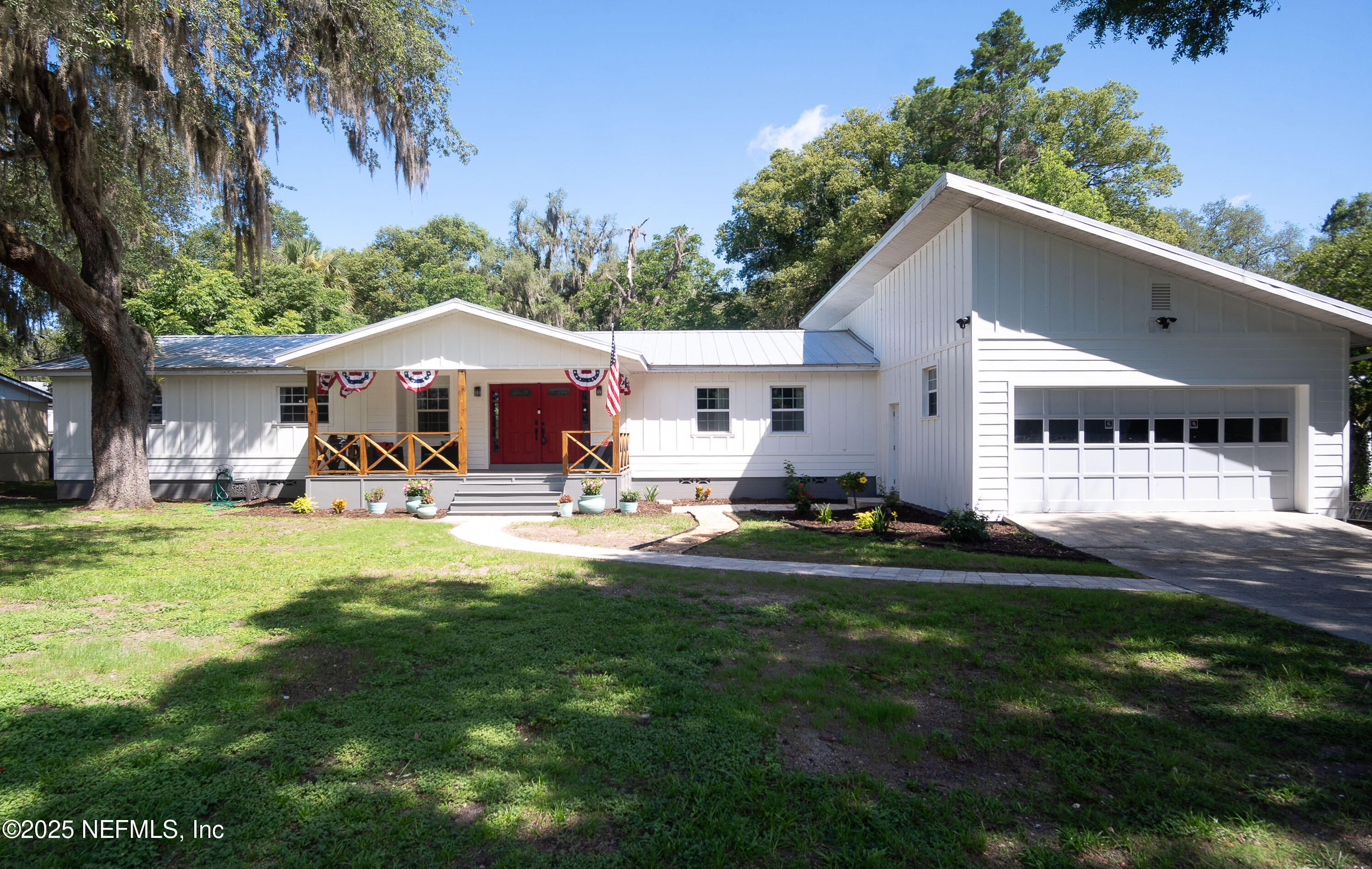 a front view of a house with yard and green space