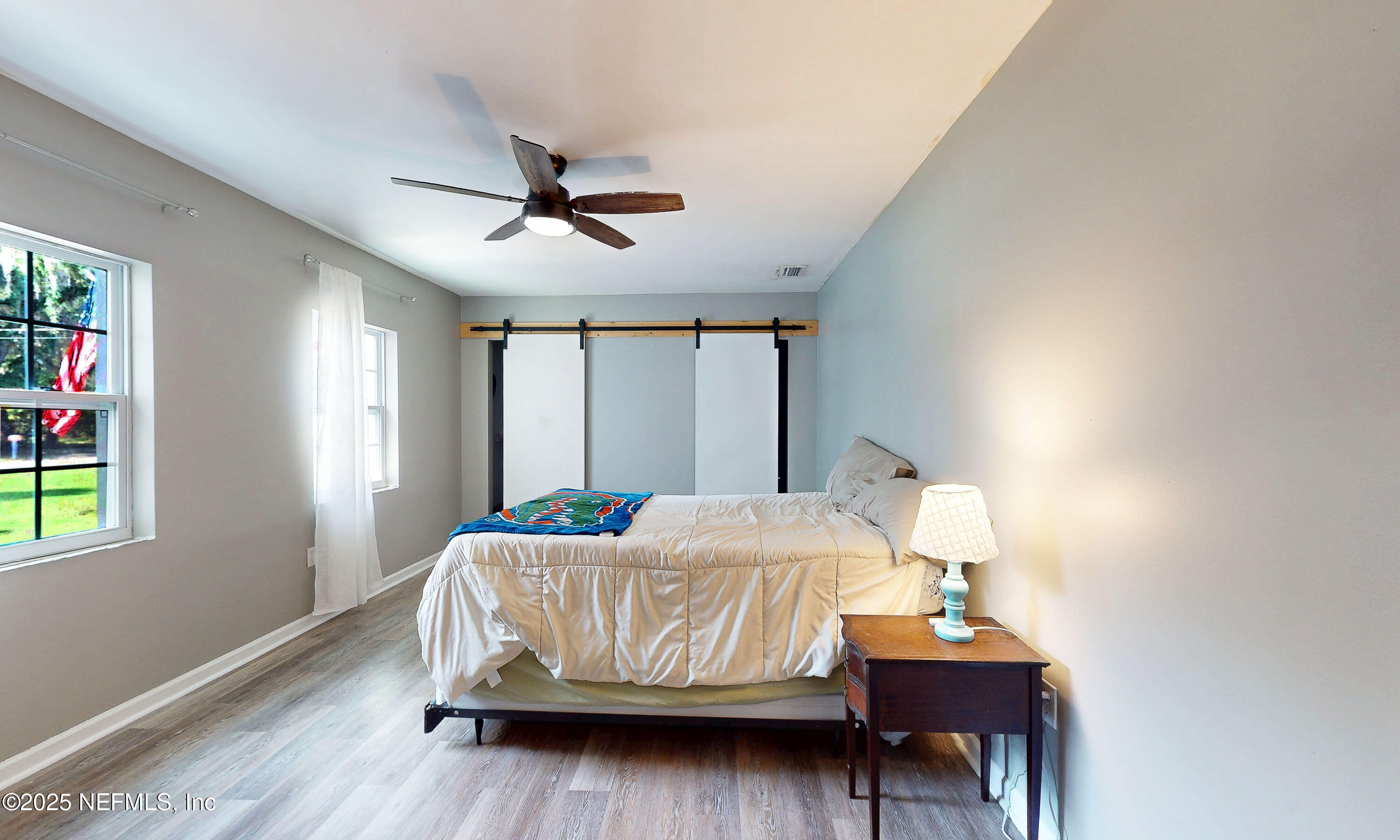 90 Forest Street Keystone Heights, FL 32656 - Photo 24 of 42 a bedroom with a bed table closet and a window