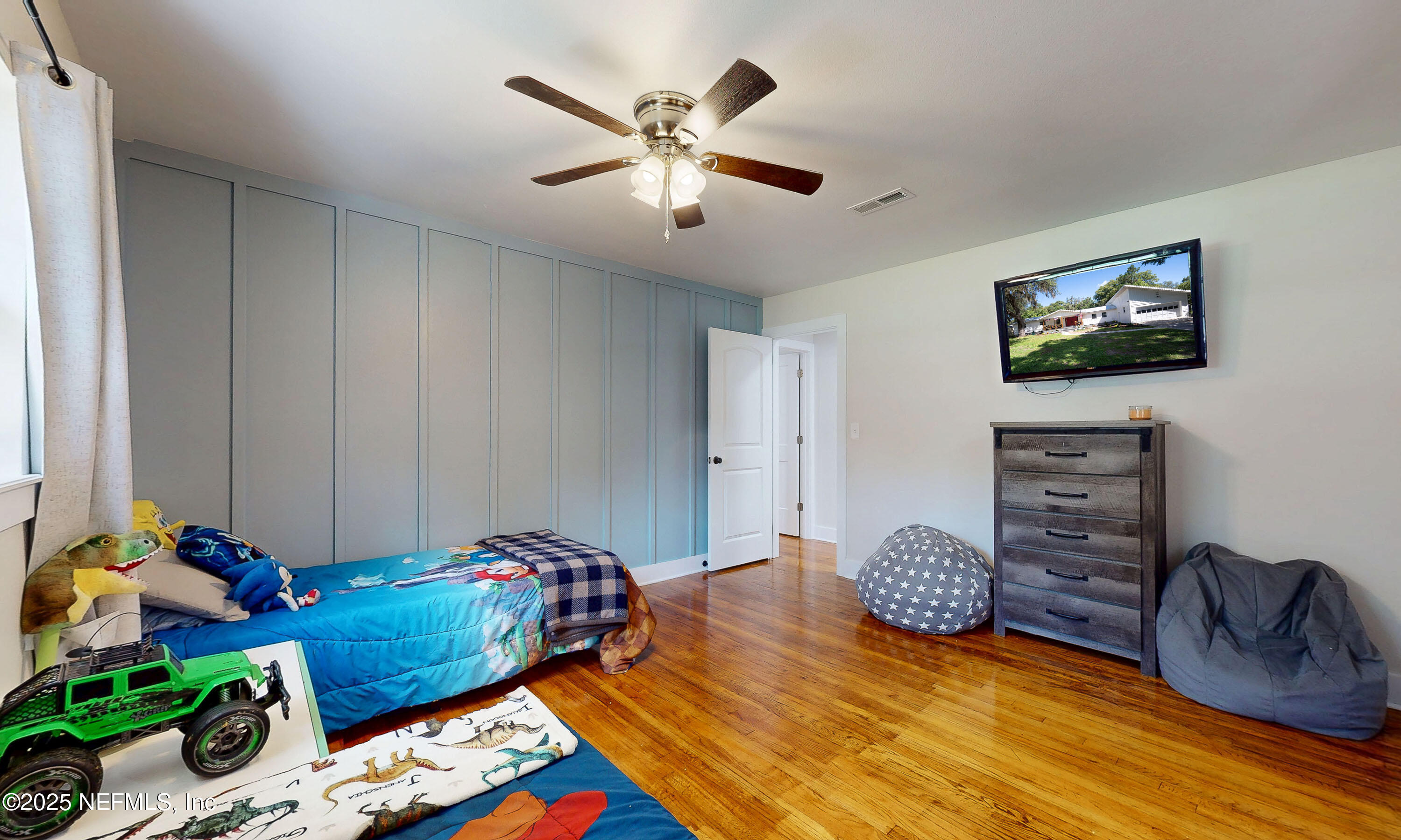 90 Forest Street Keystone Heights, FL 32656 - Photo 27 of 42 a bedroom with bed and a chandelier