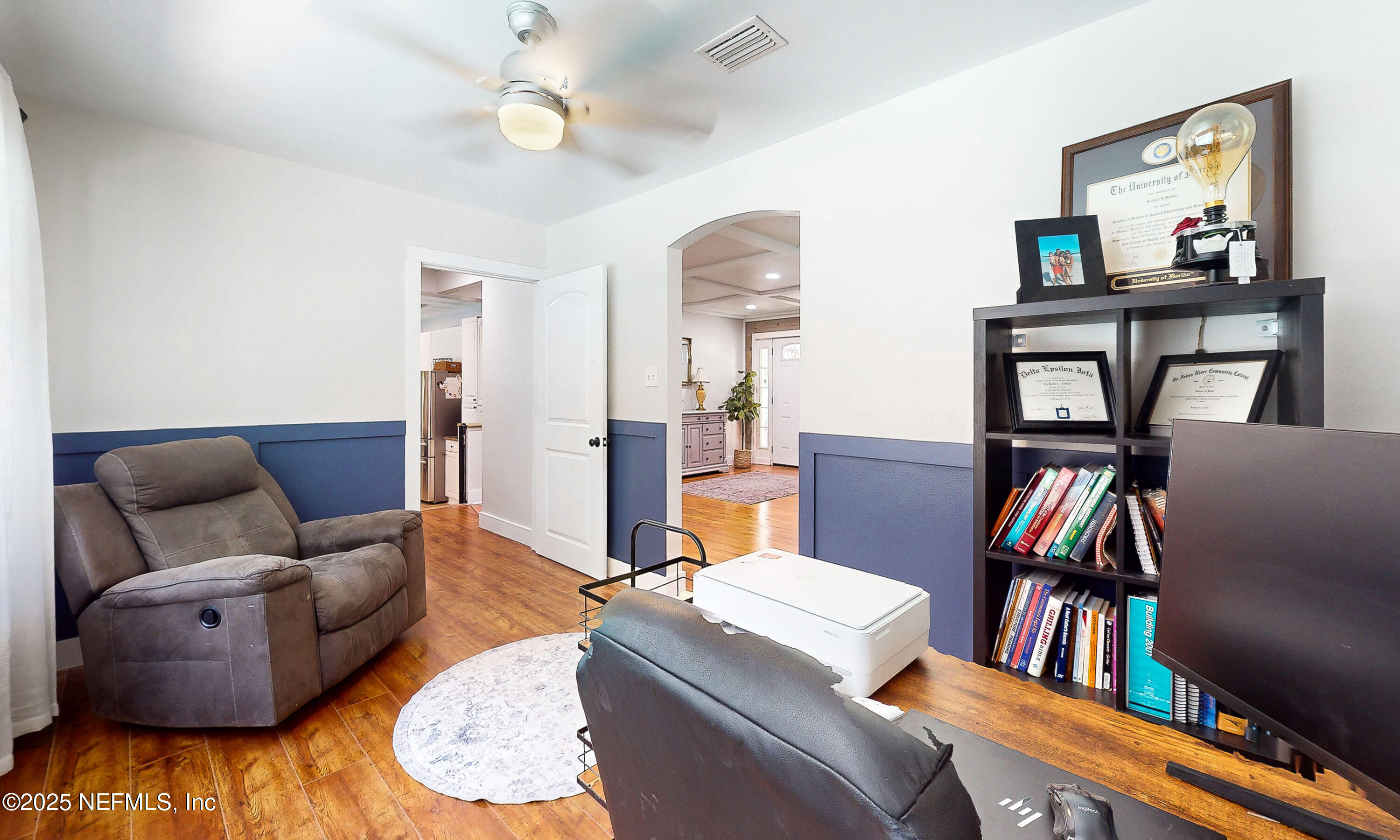 90 Forest Street Keystone Heights, FL 32656 - Photo 30 of 42 a living room with furniture and a book shelf