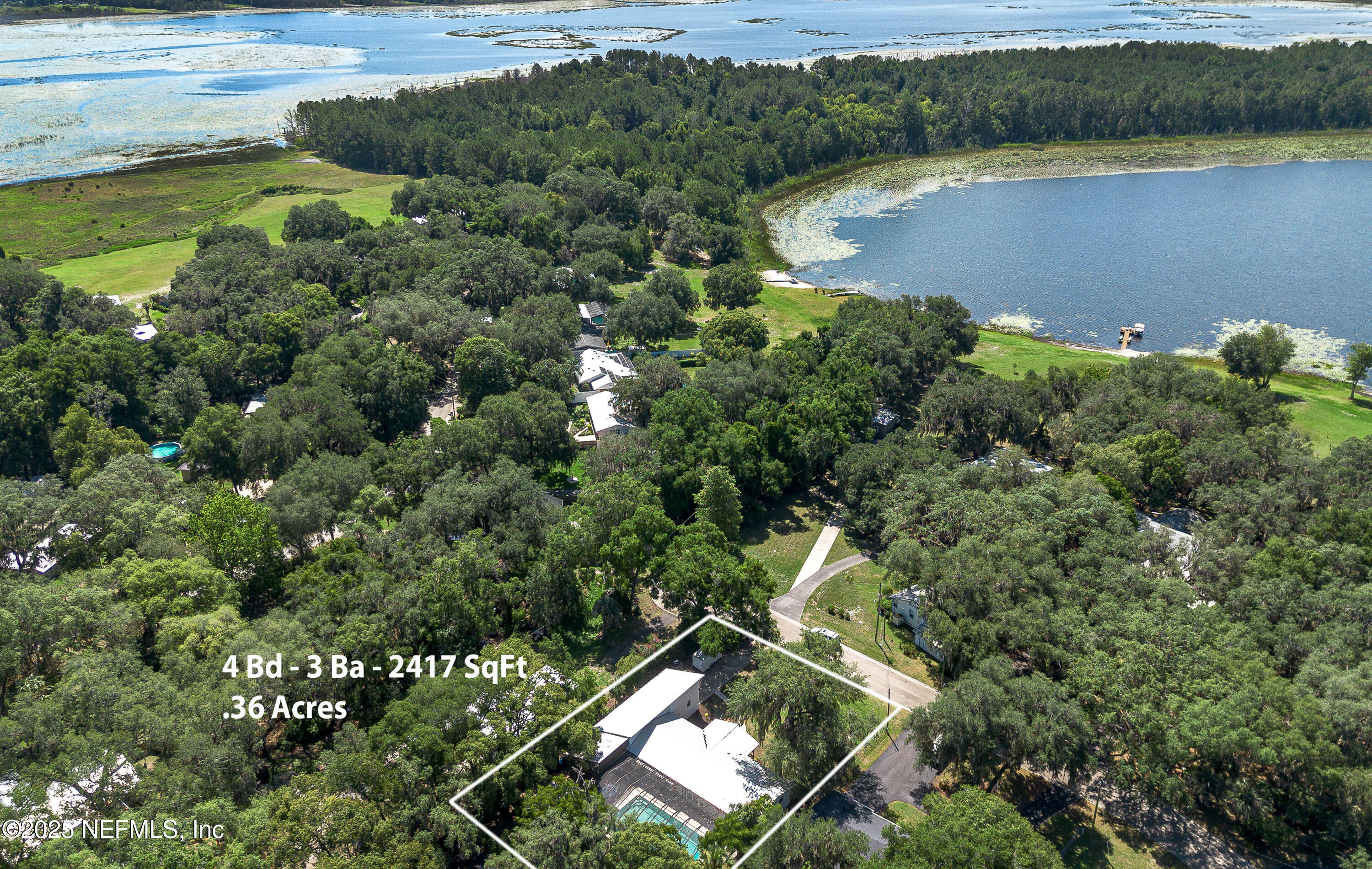 90 Forest Street Keystone Heights, FL 32656 - Photo 40 of 42 an aerial view of a house with a lake view