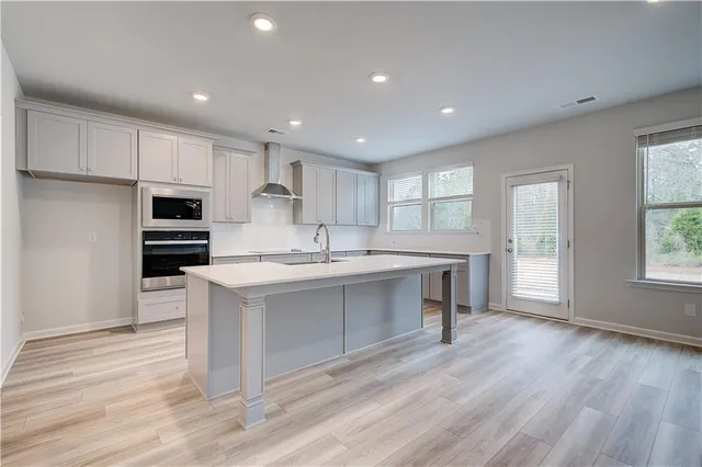a kitchen with a sink stainless steel appliances and cabinets