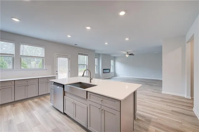 a kitchen with sink attached with living room