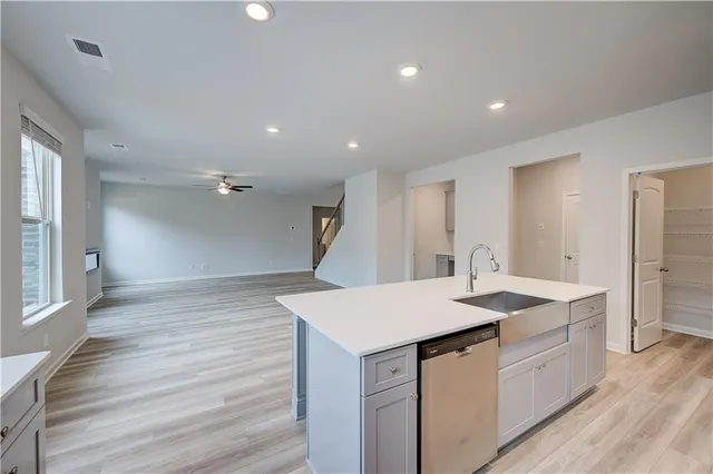 a kitchen with a sink vanity and a refrigerator