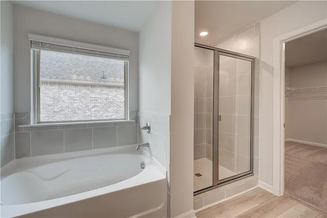 a bathroom with a bathtub and a shower