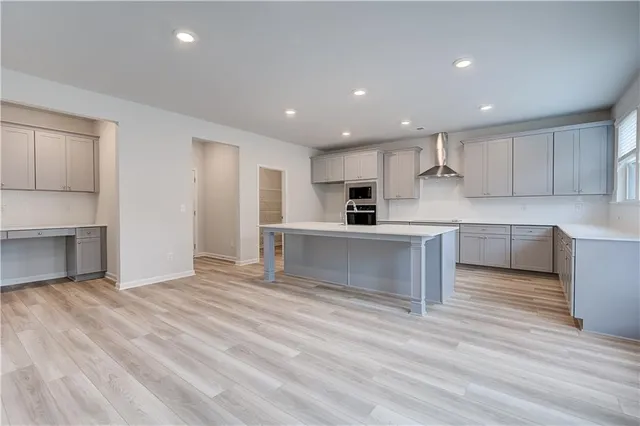 a view of kitchen with microwave and cabinets