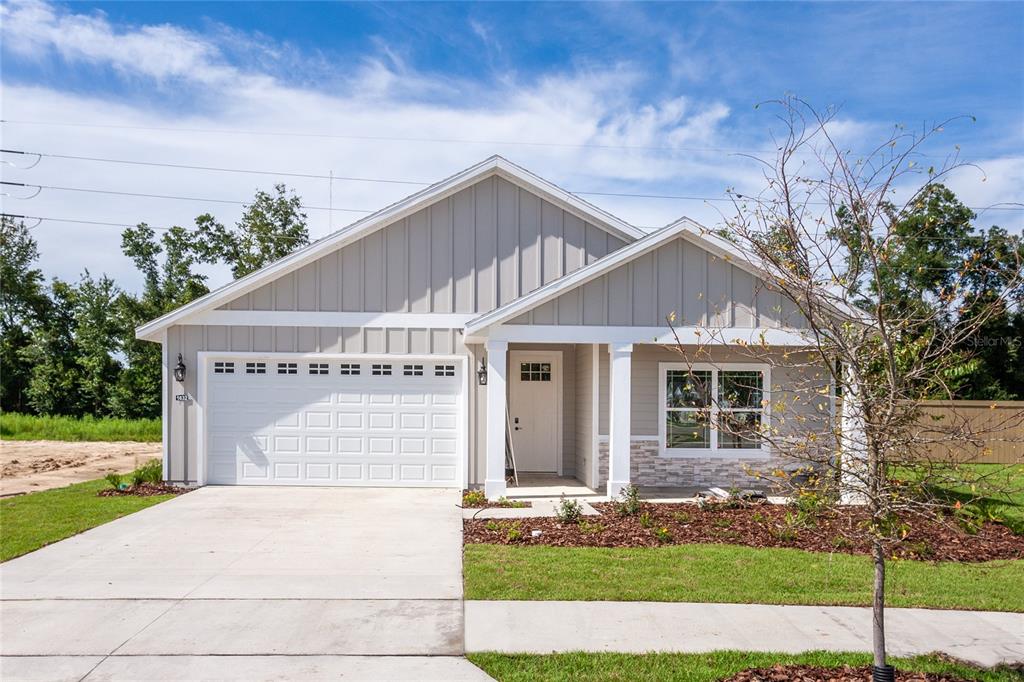 1632 Southwest 71st Circle Gainesville, FL 32607 - Photo 1 of 1 a front view of a house with a yard and garage