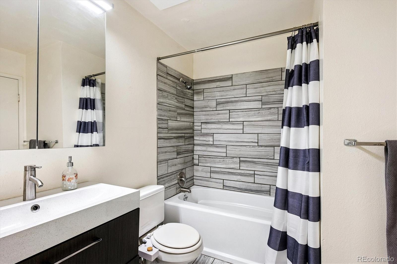 1300 Golden Circle, Unit 104 Golden, CO 80401 - Photo 14 of 26 a bathroom with a sink a toilet a shower and a mirror