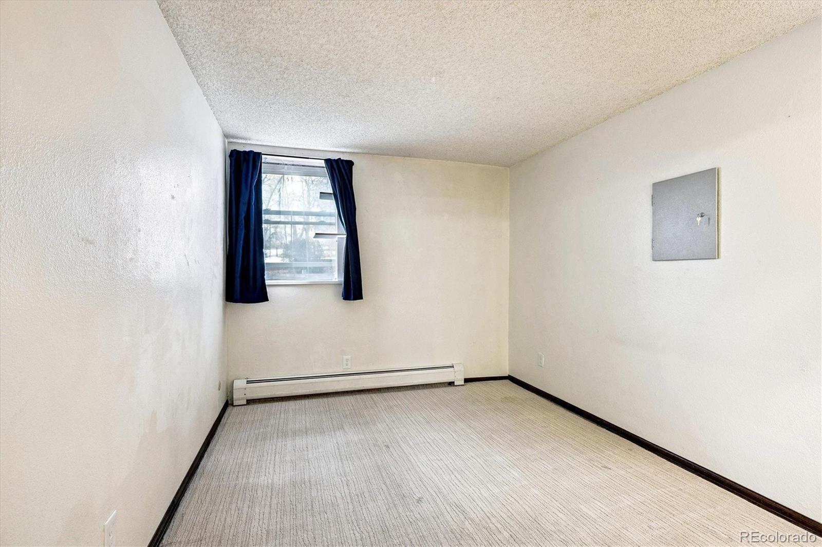 1300 Golden Circle, Unit 104 Golden, CO 80401 - Photo 15 of 26 an empty room with wooden floor and windows