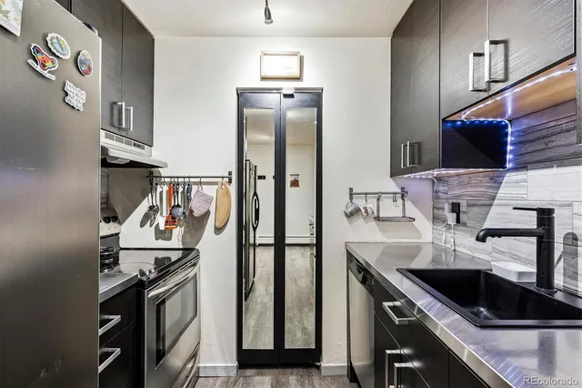 a kitchen with stainless steel appliances granite countertop a refrigerator and a stove