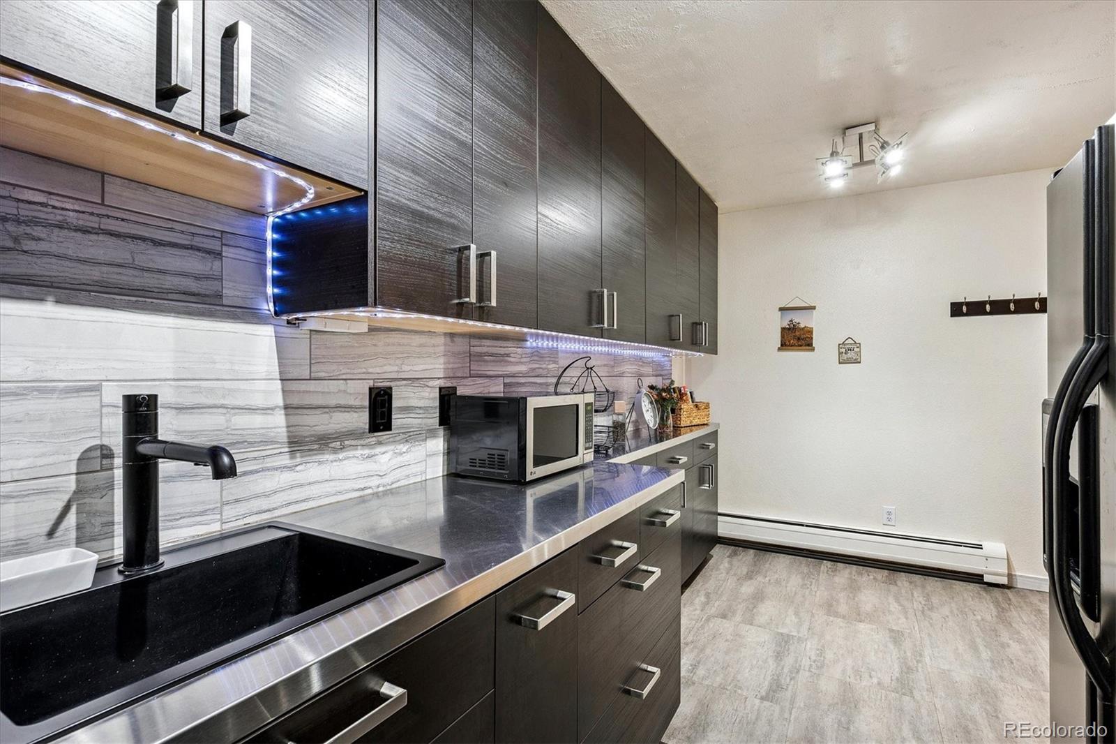 1300 Golden Circle, Unit 104 Golden, CO 80401 - Photo 7 of 26 a kitchen with stainless steel appliances a sink and a refrigerator