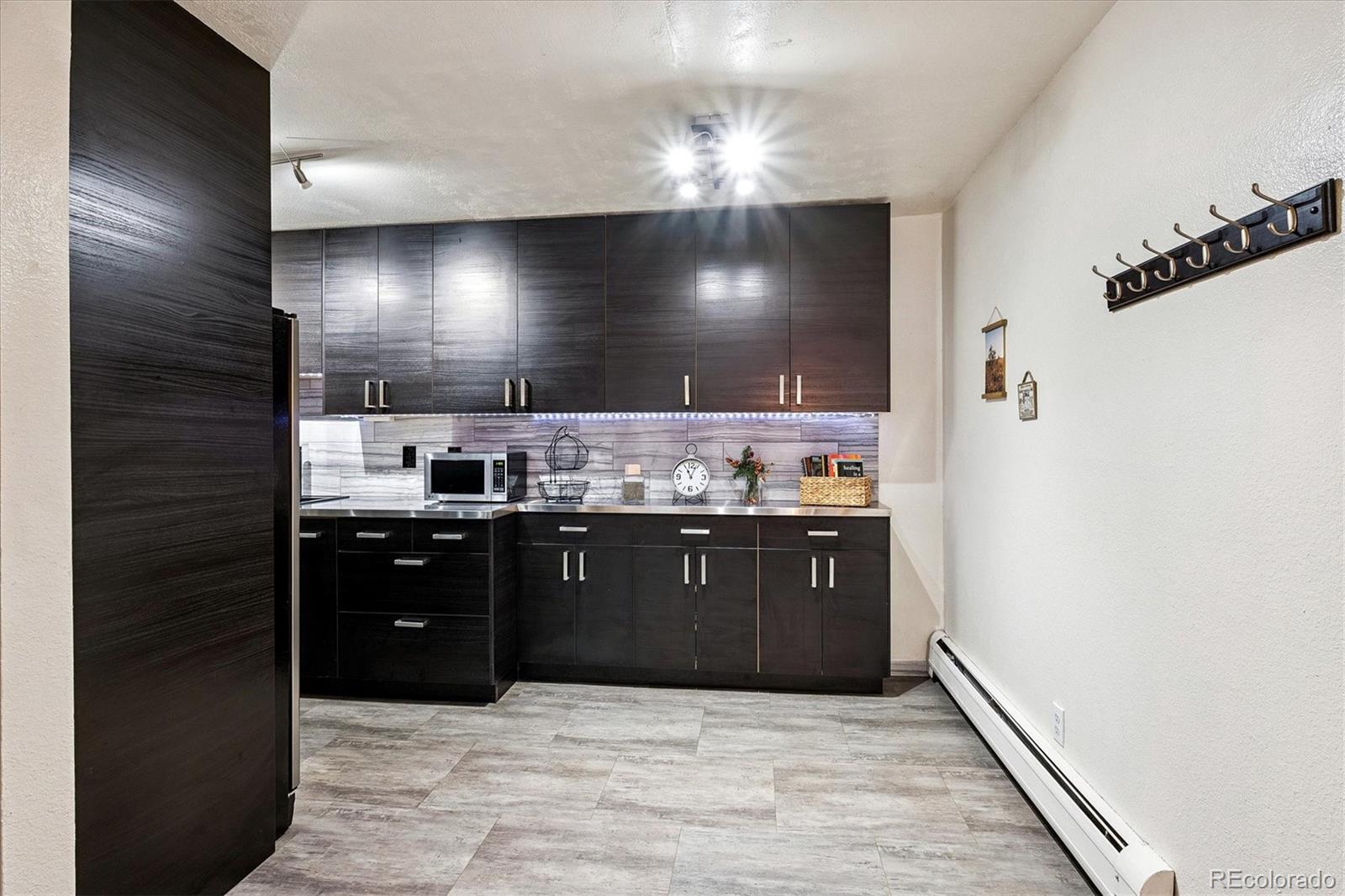 1300 Golden Circle, Unit 104 Golden, CO 80401 - Photo 9 of 26 a kitchen with stainless steel appliances granite countertop a refrigerator and a wooden cabinets