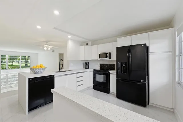 a kitchen with a refrigerator and a sink