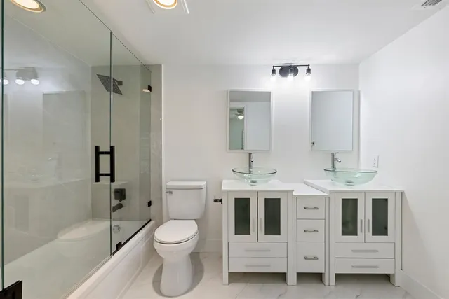 a bathroom with a toilet sink and shower