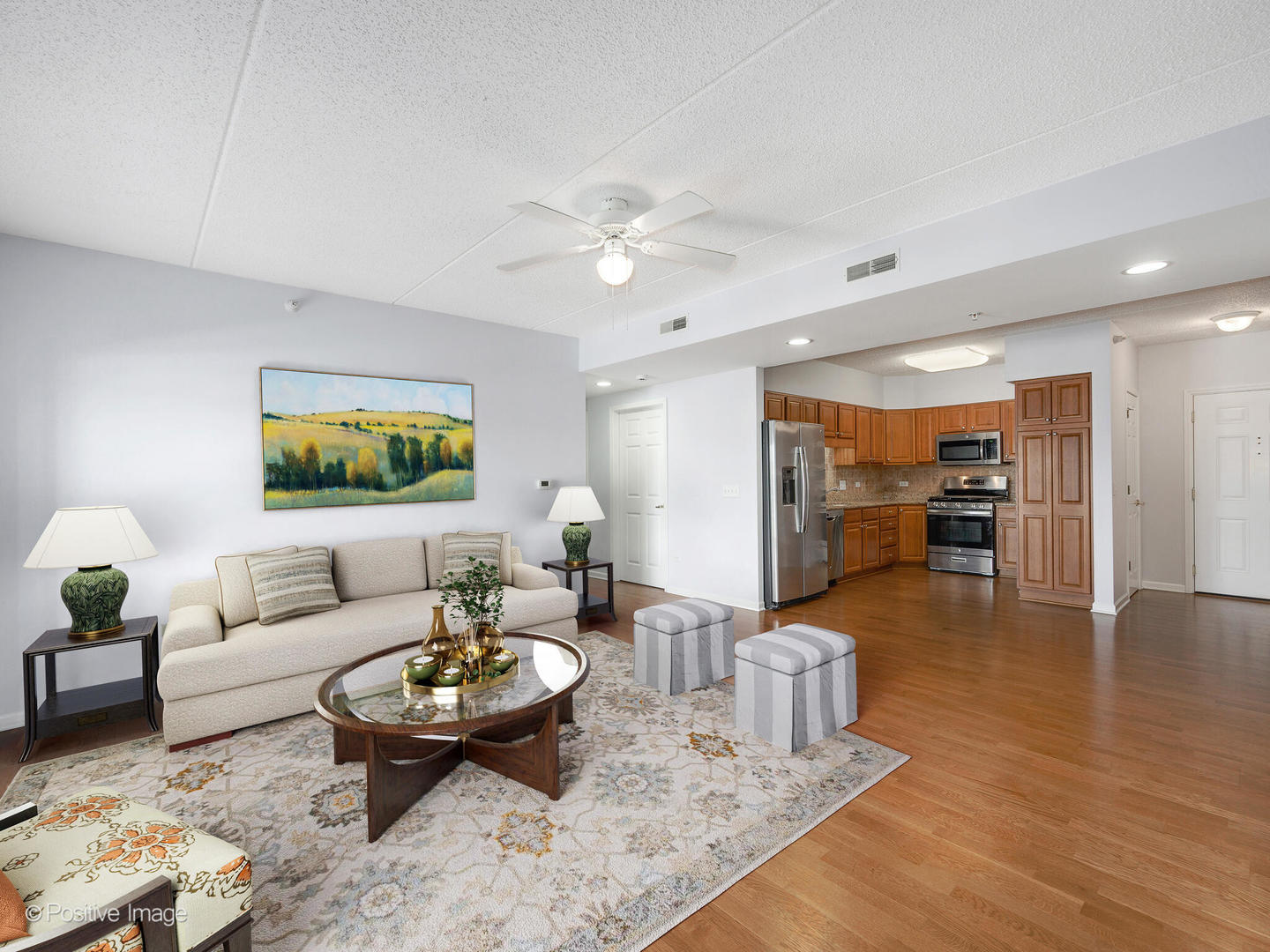 601 West Rand Road, Unit 307 Arlington Heights, IL 60004 - Photo 3 of 22 a living room with furniture and a view of kitchen