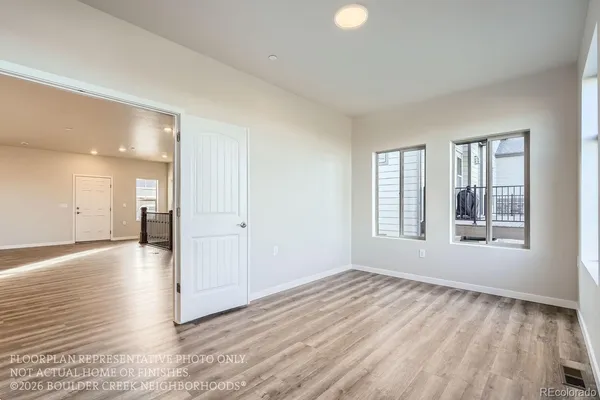 wooden floor in an empty room with a window