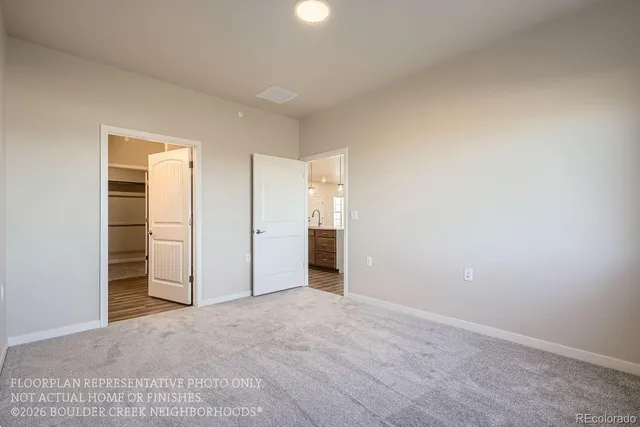 an empty room with closet and a bathroom