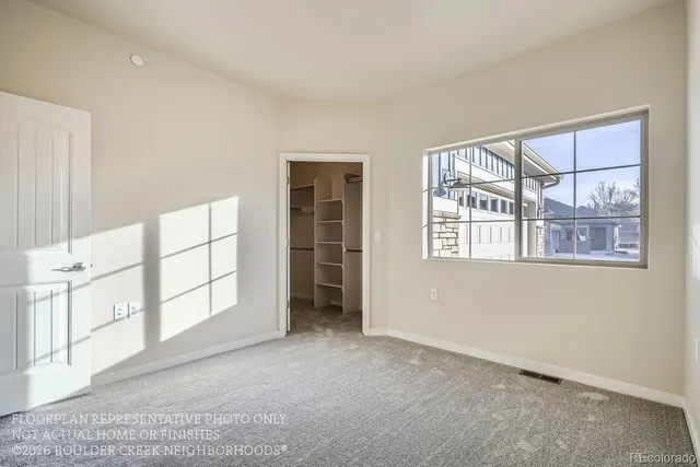 an empty room with windows and closet