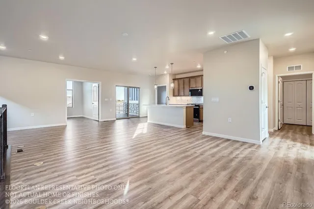 a view of a kitchen with a sink and a refrigerator