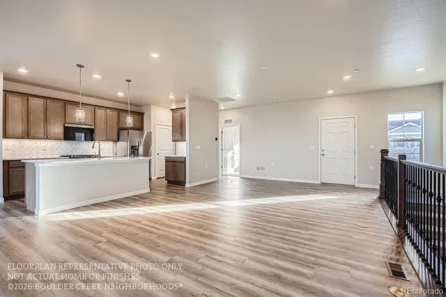 a view of a kitchen with a sink and a refrigerator