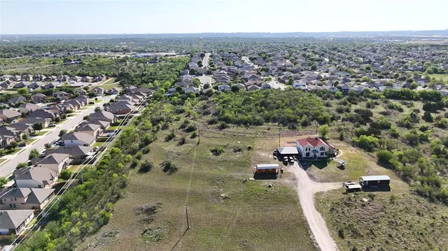 an aerial view of a house with a yard