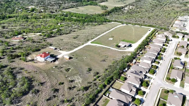 an aerial view of residential houses with outdoor space
