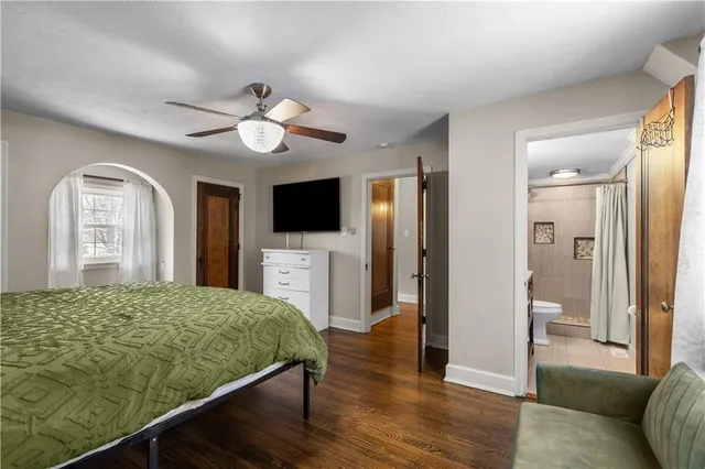 a living room with a bed furniture and a flat screen tv