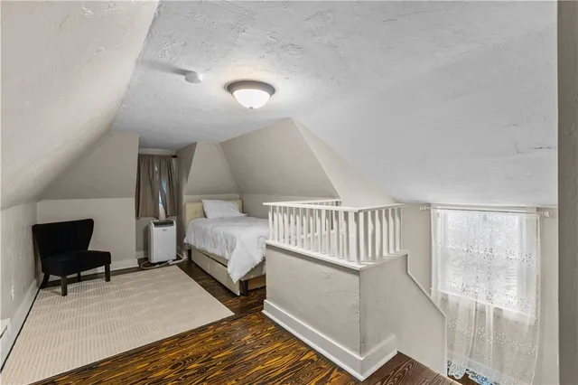 a bedroom with furniture and a window