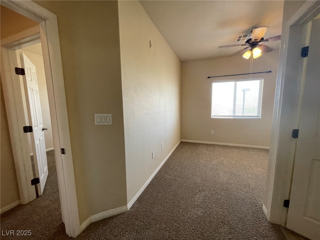 10519 Hedge View Avenue Las Vegas, NV 89129 - Photo 15 of 39 Carpeted spare room with baseboards and ceiling fa