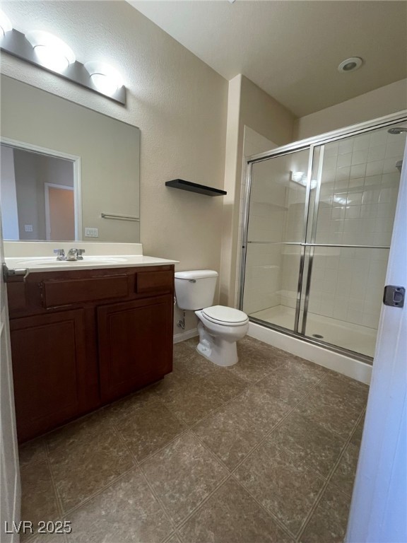 10519 Hedge View Avenue Las Vegas, NV 89129 - Photo 20 of 39 Bathroom with a stall shower, toilet, and vanity