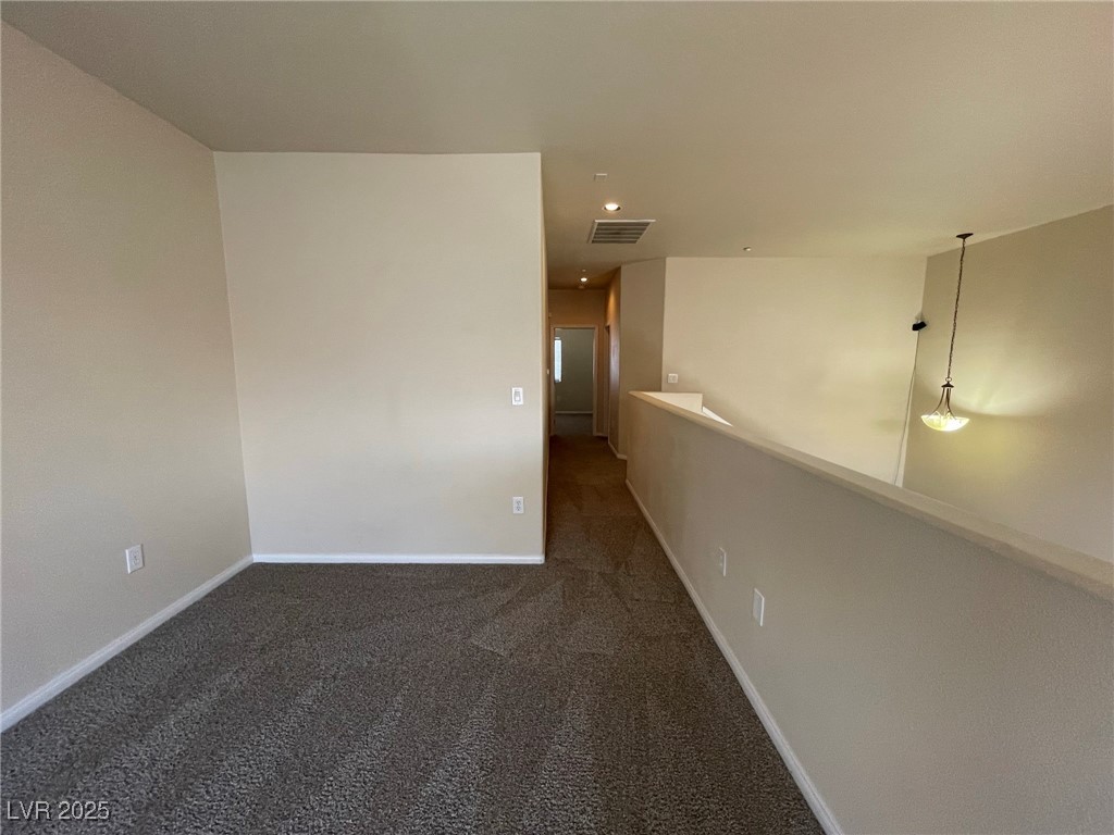 10519 Hedge View Avenue Las Vegas, NV 89129 - Photo 31 of 39 Carpeted spare room featuring baseboards and visib