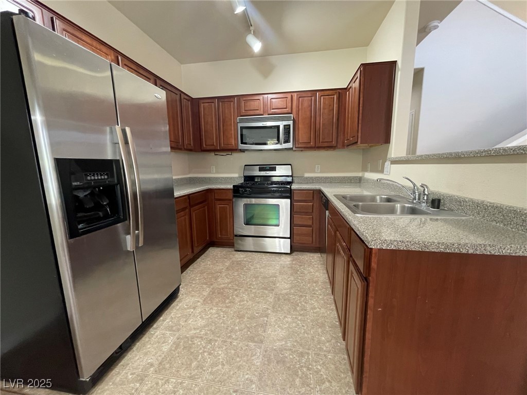 10519 Hedge View Avenue Las Vegas, NV 89129 - Photo 5 of 39 Kitchen featuring track lighting, stainless steel