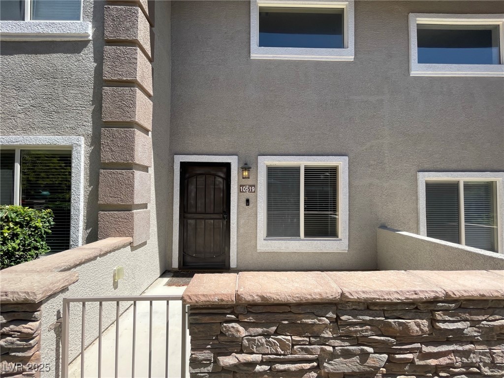 10519 Hedge View Avenue Las Vegas, NV 89129 - Photo 6 of 39 Property entrance featuring visible vents and stuc
