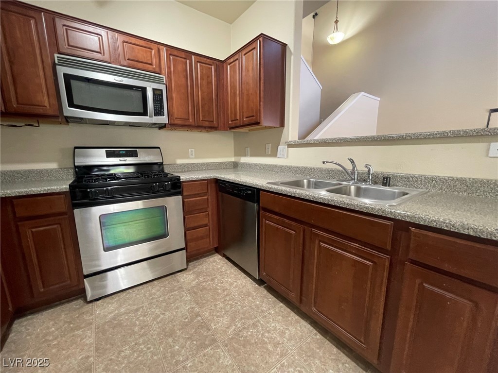 10519 Hedge View Avenue Las Vegas, NV 89129 - Photo 8 of 39 Kitchen featuring a sink, light countertops, and s