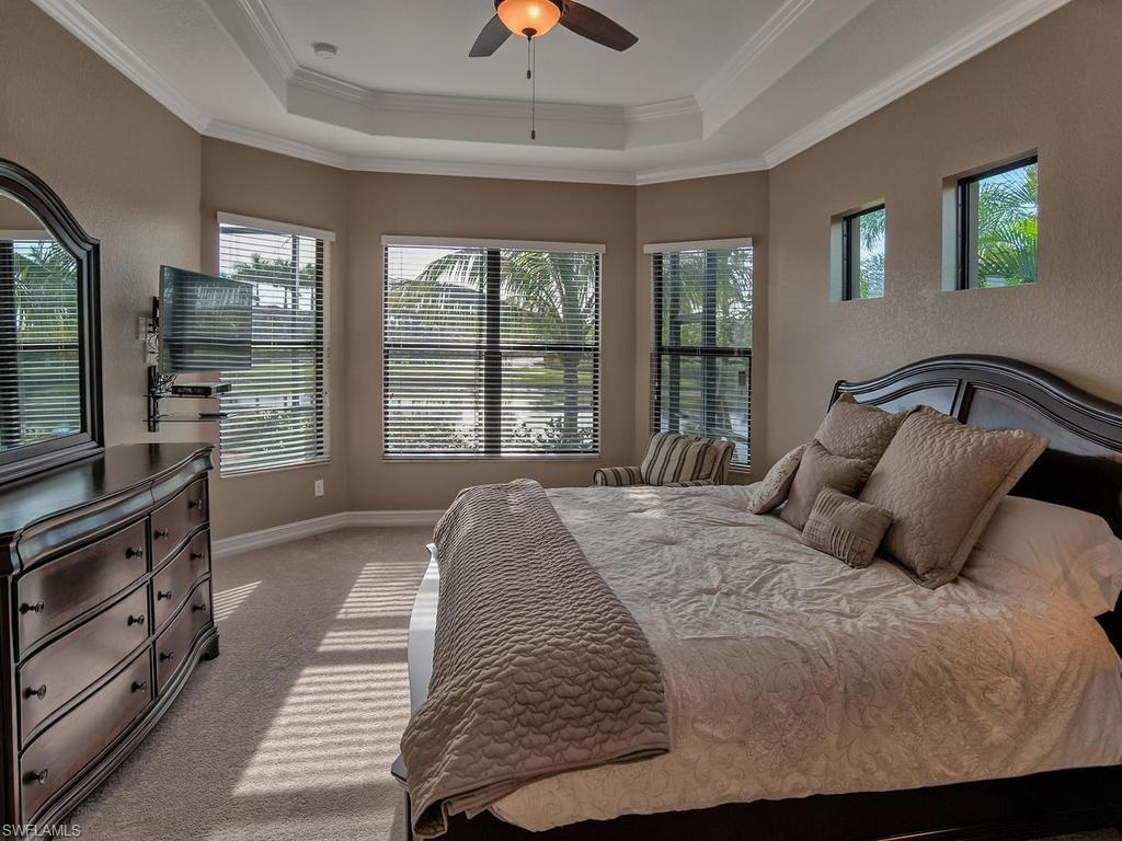 9634 Firenze Circle Naples, FL 34113 - Photo 10 of 35 a bedroom with a large bed and a large window