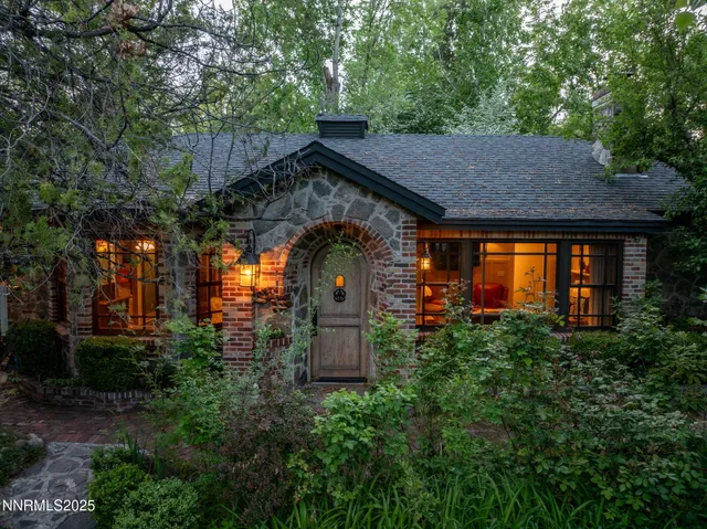 a backyard of a house with plants and outdoor seating