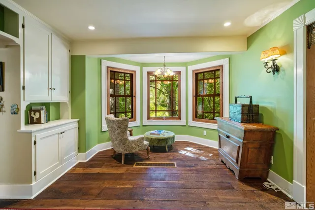 a view of a chair and table in backyard of the house