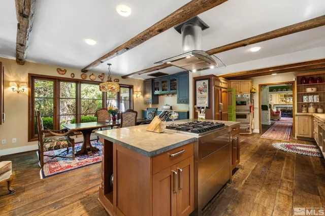 a kitchen with stainless steel appliances a stove refrigerator sink and microwave