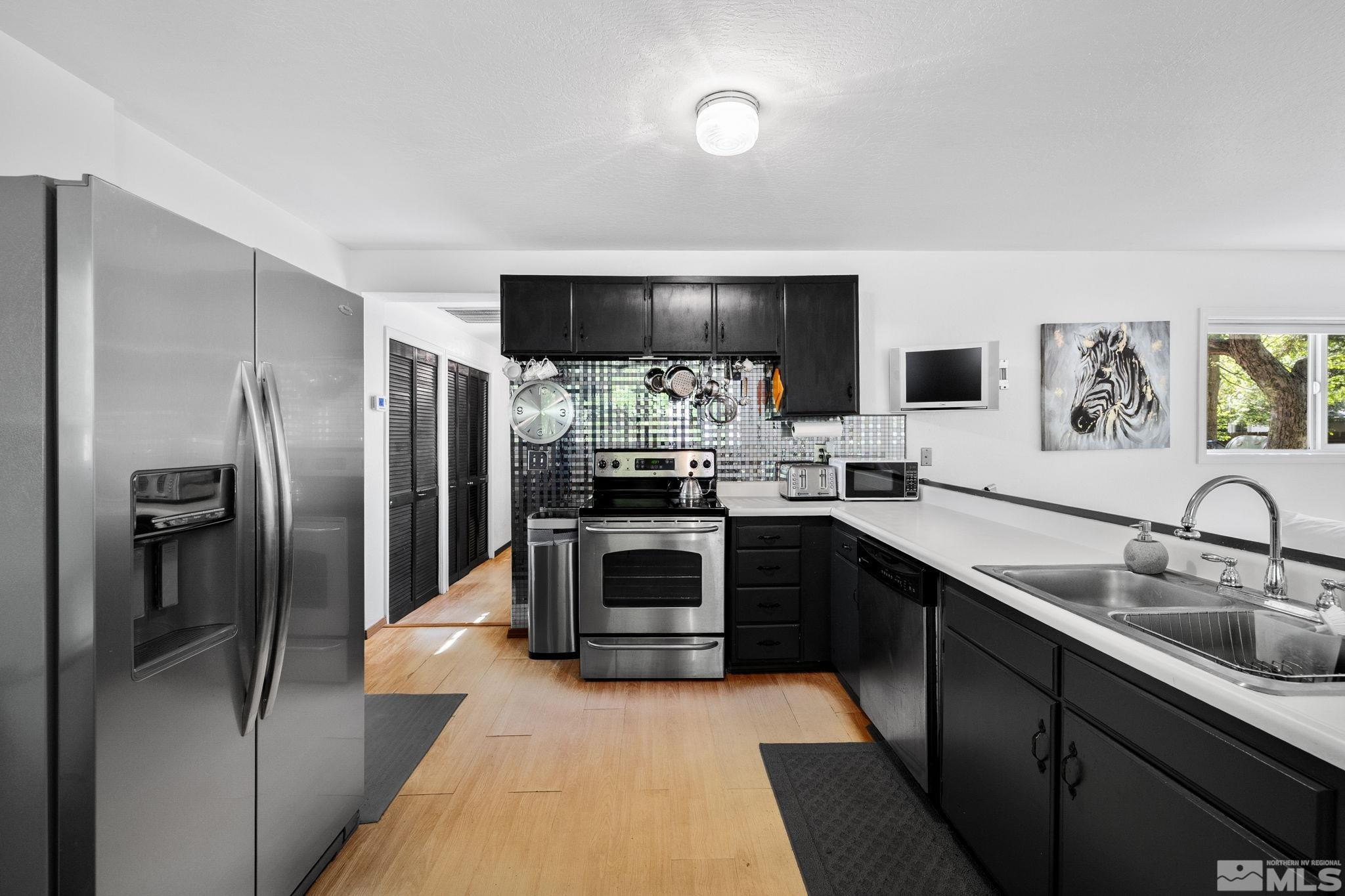 1555 Marsh Avenue Reno, NV 89509 - Photo 51 of 84 a kitchen with a refrigerator and a sink