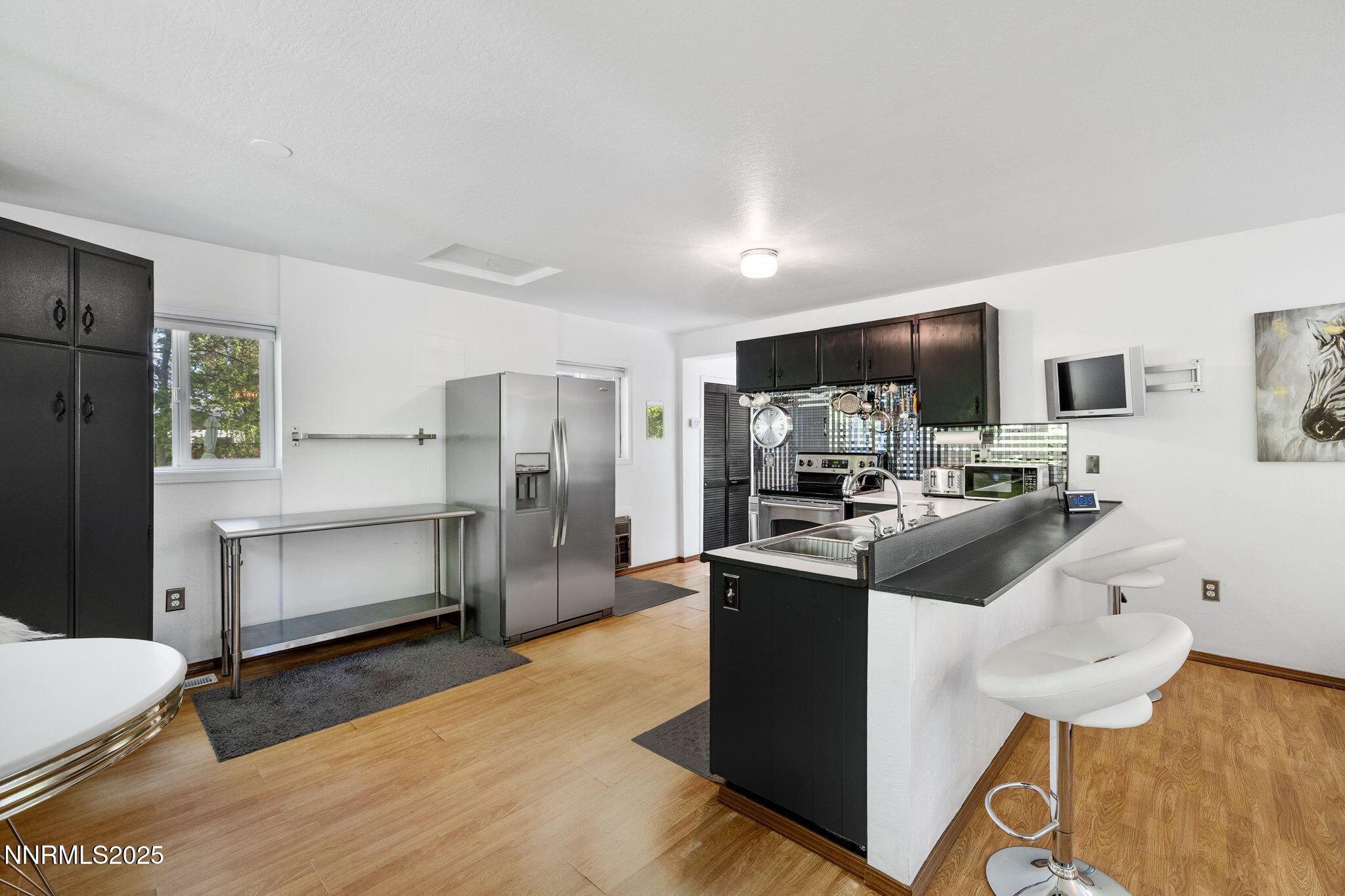 1555 Marsh Avenue Reno, NV 89509 - Photo 53 of 84 a kitchen with stainless steel appliances a stove refrigerator sink and microwave