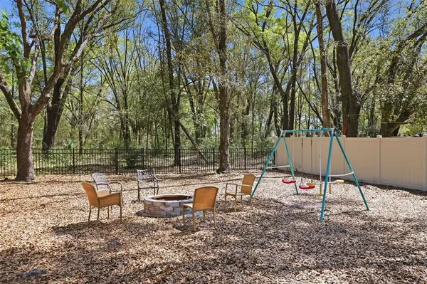 a backyard of a house with table and chairs