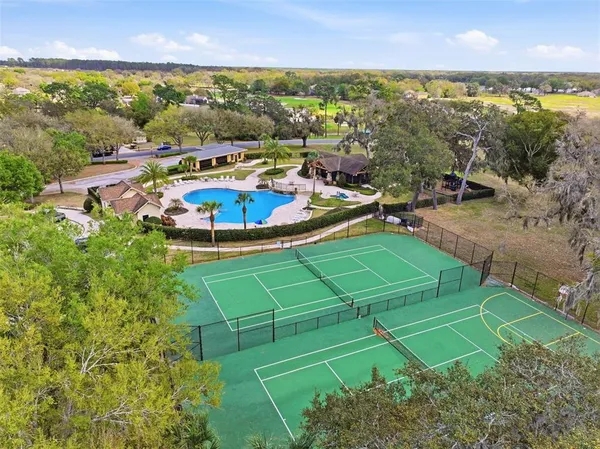 a view of a big yard with an ocean view