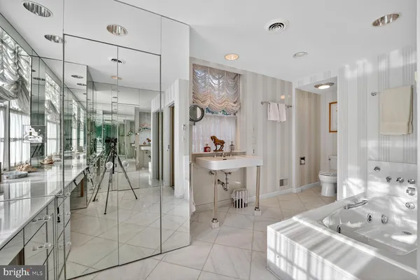 a large space with a large mirror vanity and furniture