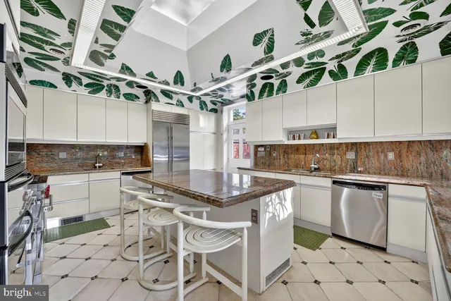 a kitchen with stainless steel appliances granite countertop a sink a stove and cabinets