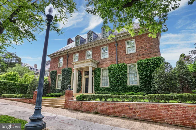 a front view of a house with a garden and plants
