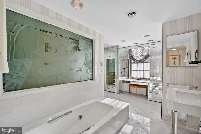 a bathroom with a bathtub a sink and a shower