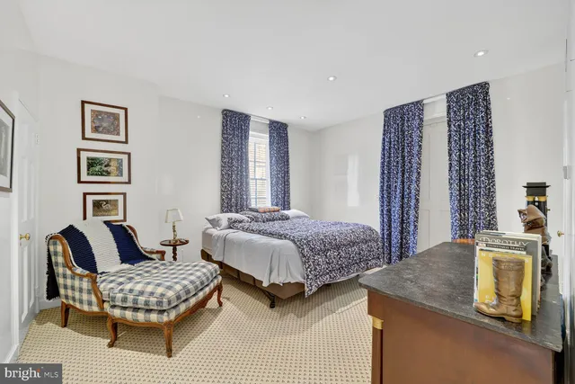 a bedroom with a bed and a couch